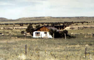 Typical dry river bed and abandoned house along the highway in Colorado